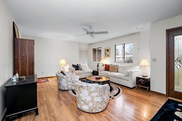 living room featuring ceiling fan and light hardwood / wood-style floors