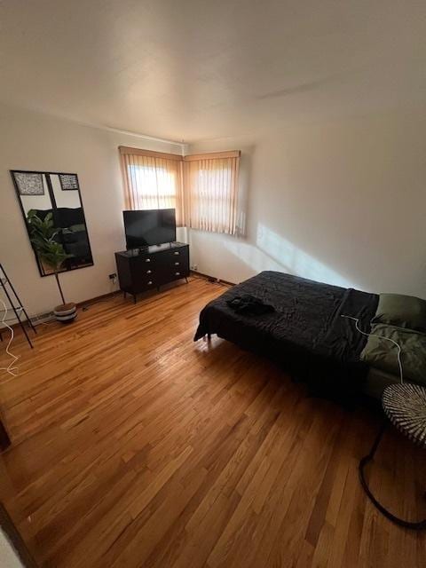 bedroom with hardwood / wood-style flooring