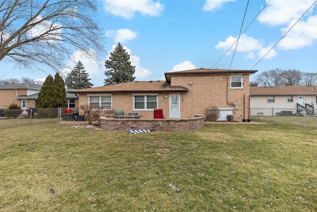 rear view of house featuring a lawn