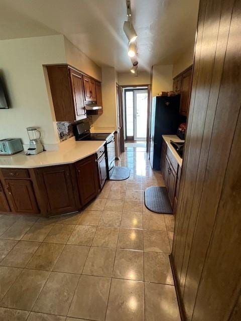 kitchen featuring fridge, rail lighting, black range with electric cooktop, and light tile patterned floors