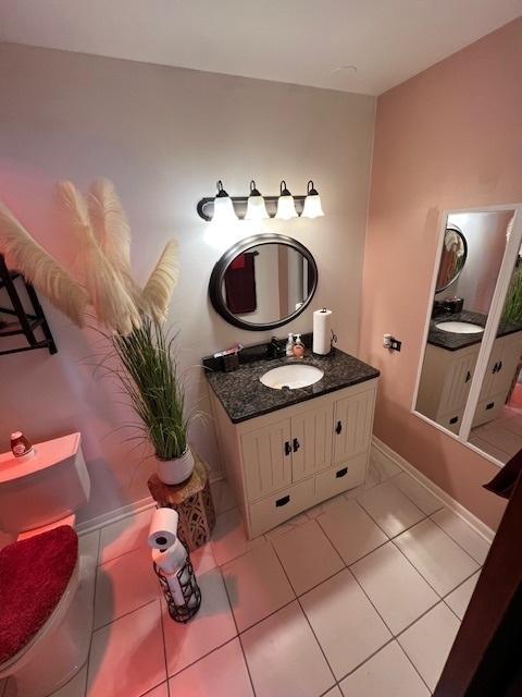 bathroom featuring vanity, tile patterned flooring, and toilet