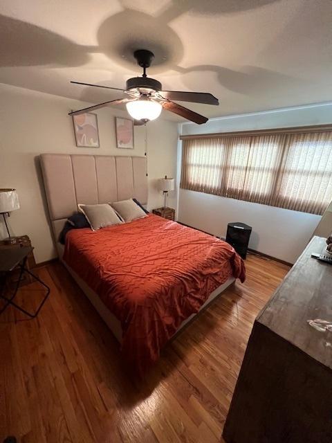 bedroom with hardwood / wood-style flooring and ceiling fan