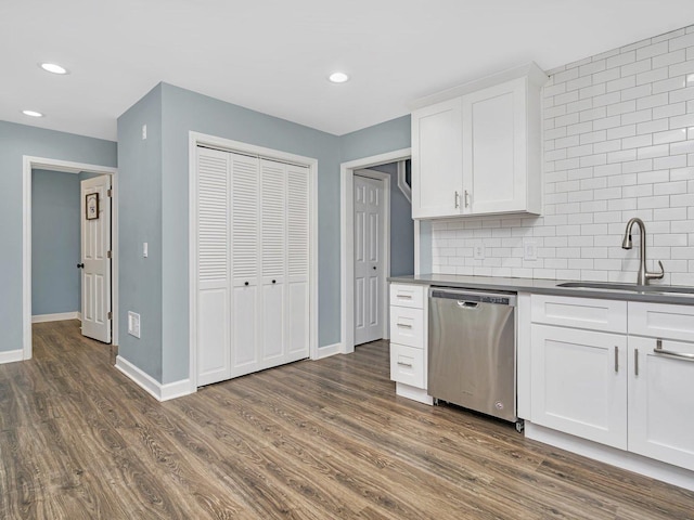 kitchen featuring sink, white cabinets, stainless steel dishwasher, and dark hardwood / wood-style floors