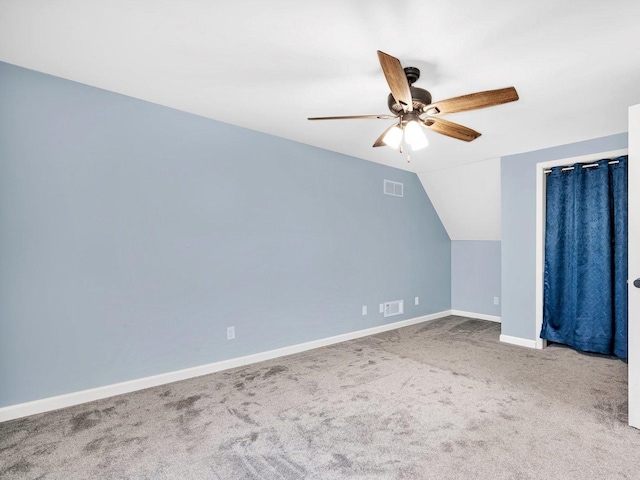 additional living space with ceiling fan, carpet floors, and vaulted ceiling