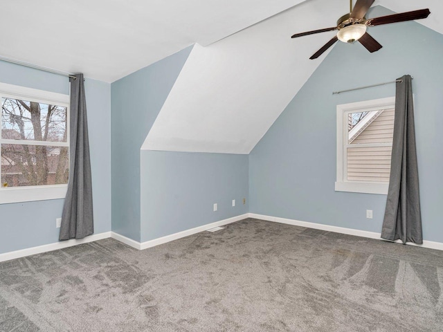 additional living space with carpet floors and vaulted ceiling