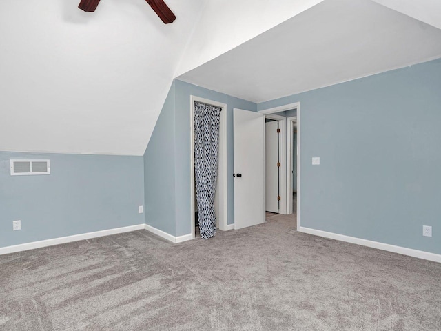 bonus room with ceiling fan, light colored carpet, and lofted ceiling