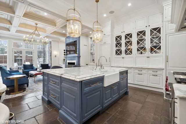 kitchen with white cabinets, hanging light fixtures, beamed ceiling, and coffered ceiling