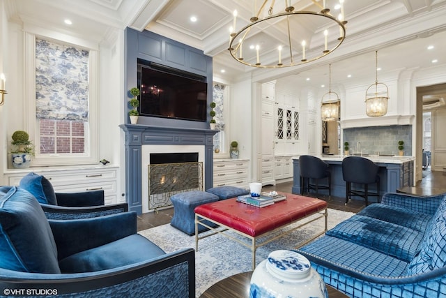 living room featuring beamed ceiling, a notable chandelier, crown molding, and coffered ceiling