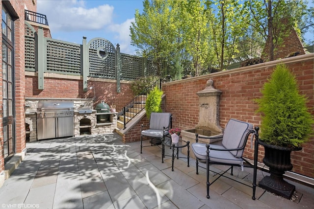 view of patio / terrace featuring a grill and exterior kitchen