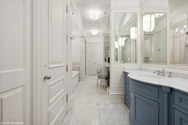 bathroom featuring vanity and a tub to relax in