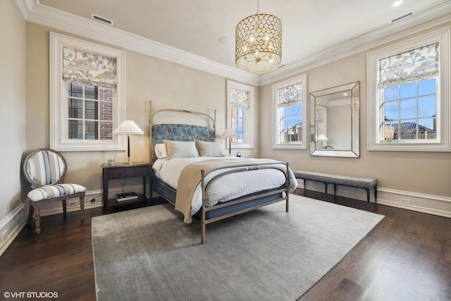 bedroom featuring crown molding, dark hardwood / wood-style flooring, and a notable chandelier