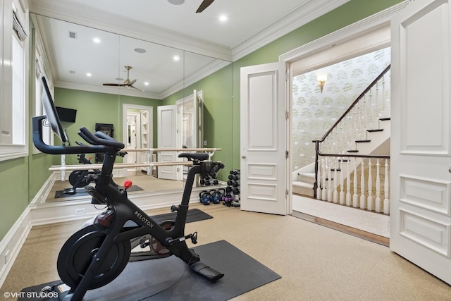 workout room featuring carpet flooring, ceiling fan, and crown molding