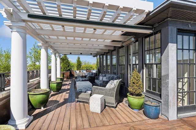 wooden terrace featuring a pergola and an outdoor hangout area