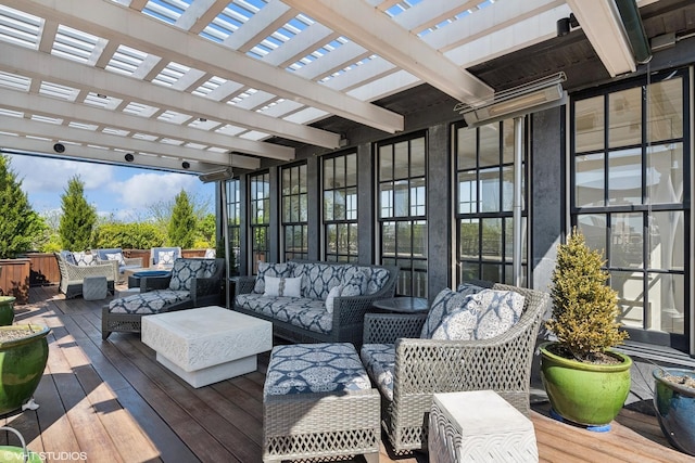 wooden deck with an outdoor hangout area and a pergola