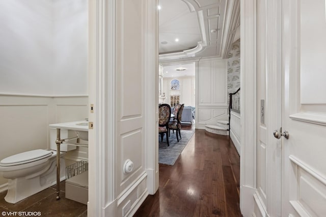 bathroom featuring hardwood / wood-style flooring, toilet, and a raised ceiling