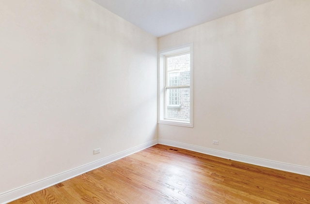 unfurnished room with light wood-type flooring