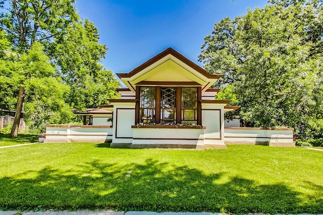 rear view of property with a lawn