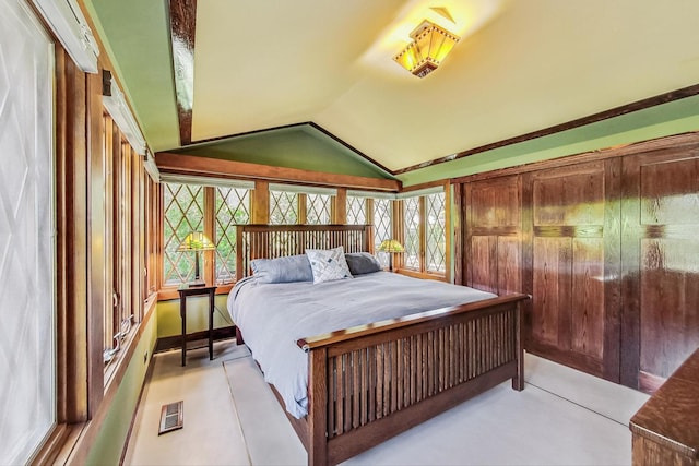 bedroom featuring lofted ceiling and visible vents