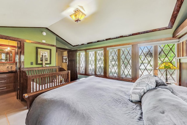 bedroom with vaulted ceiling, multiple windows, and carpet