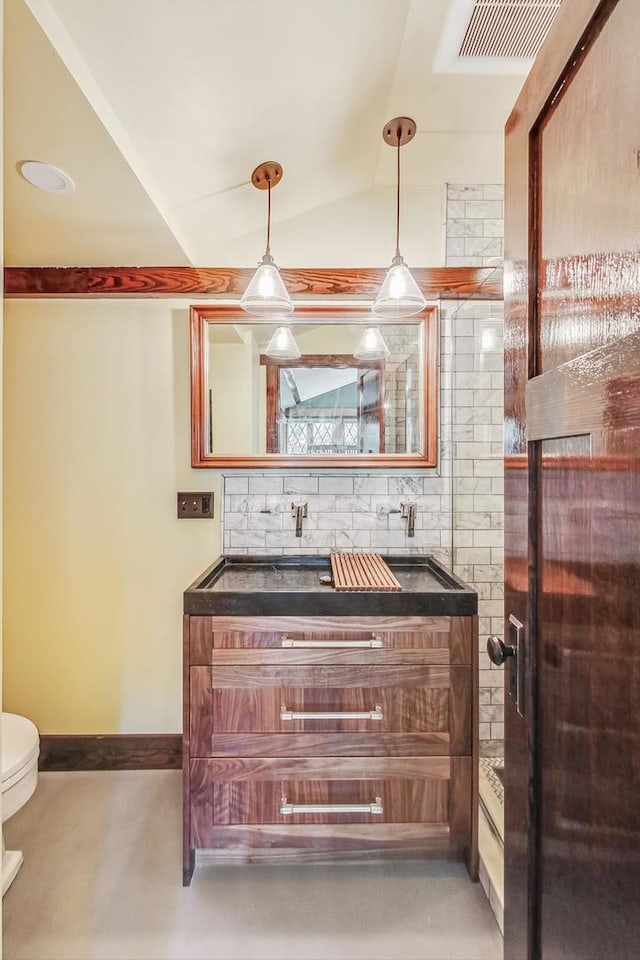 bathroom featuring tasteful backsplash, visible vents, toilet, vaulted ceiling, and vanity