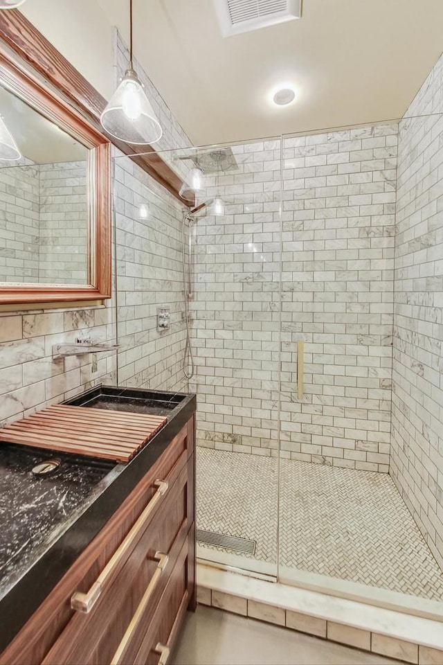 full bath with backsplash, visible vents, a shower stall, and vanity