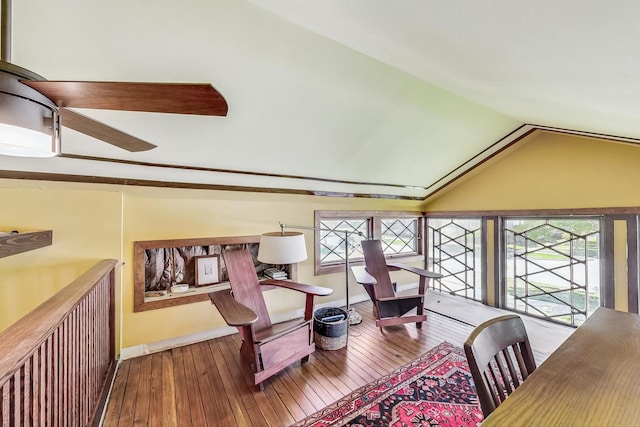 living area featuring vaulted ceiling and hardwood / wood-style floors