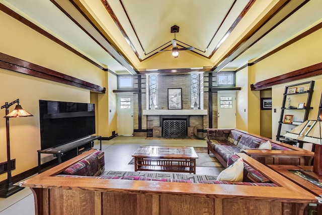 living area with plenty of natural light, a fireplace, and crown molding