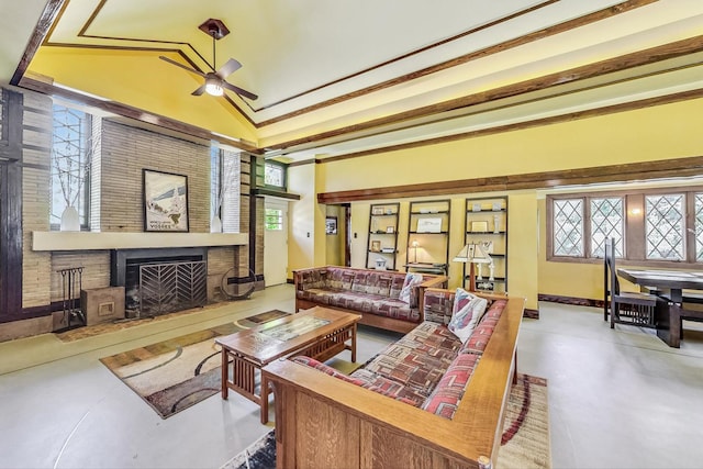 living area featuring ceiling fan, lofted ceiling, concrete flooring, a large fireplace, and baseboards