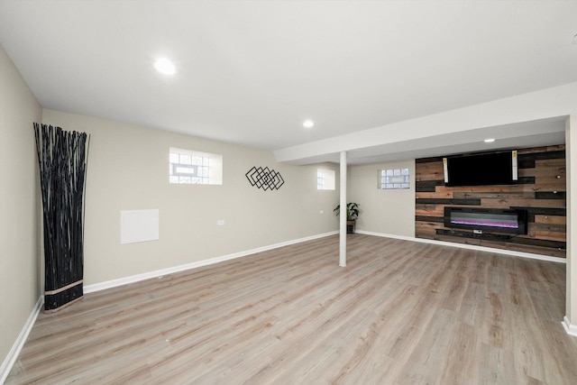 basement with light hardwood / wood-style floors