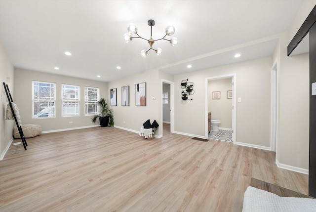 interior space featuring a chandelier and light hardwood / wood-style floors