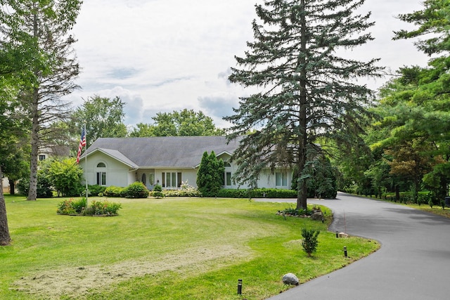 ranch-style home featuring a front yard