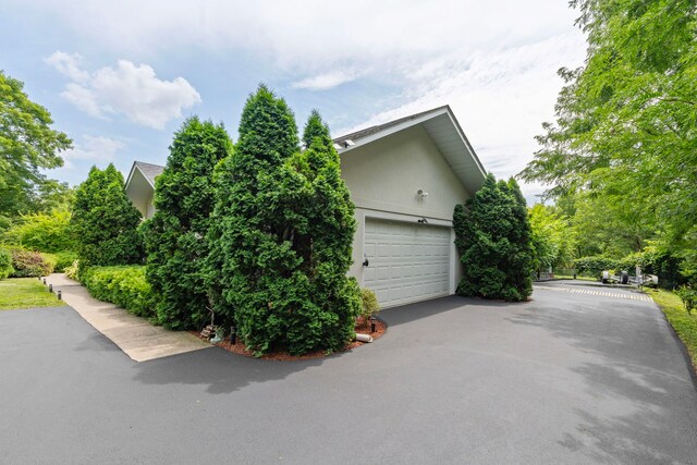 view of property exterior featuring a garage