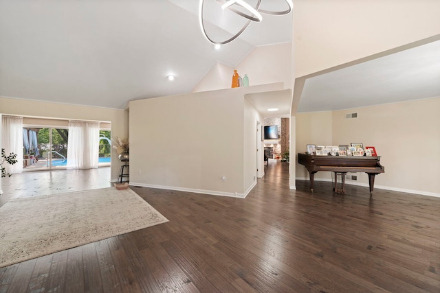 living room with a stone fireplace, dark wood-type flooring, and high vaulted ceiling