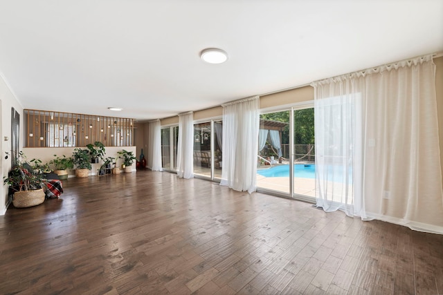 unfurnished living room with dark wood-type flooring