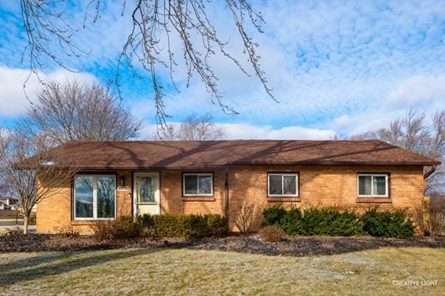 ranch-style house with a front lawn