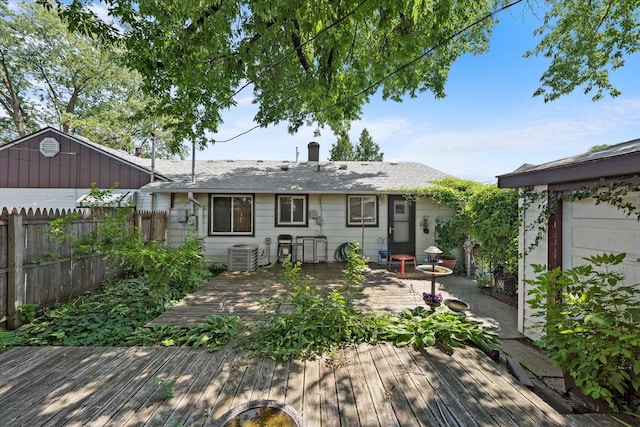 back of property featuring a wooden deck and cooling unit