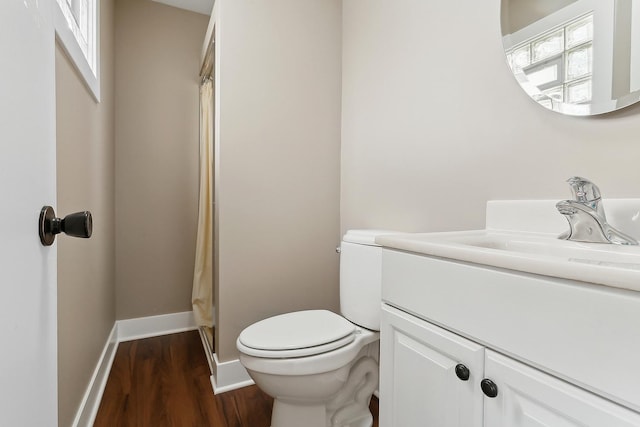 bathroom with vanity, wood-type flooring, and toilet