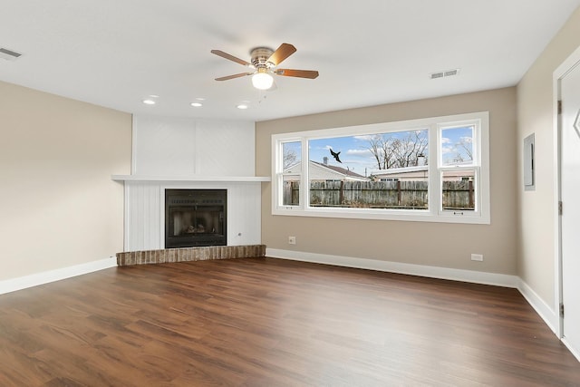 unfurnished living room with plenty of natural light, ceiling fan, and dark wood-type flooring