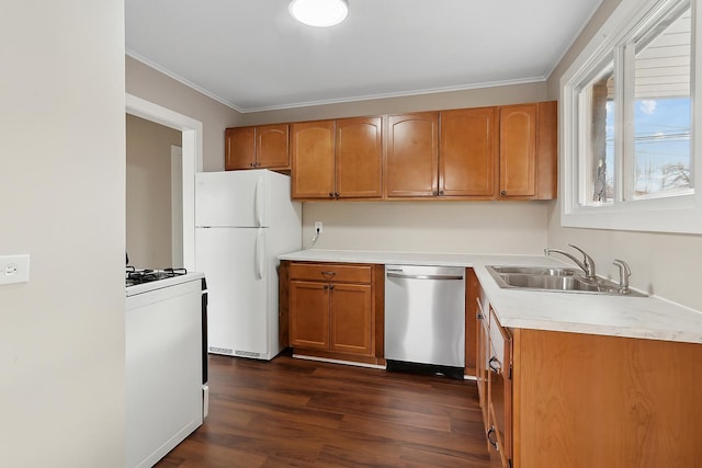 kitchen with crown molding, dark hardwood / wood-style flooring, white appliances, and sink