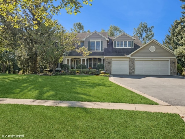 view of front of property featuring a garage and a front yard