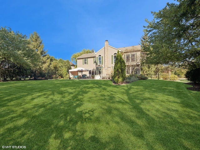 back of house with a lawn