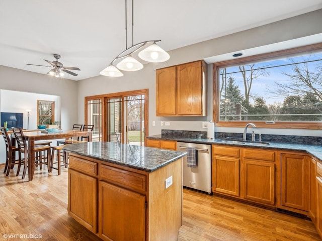 kitchen with light wood-type flooring, ceiling fan, sink, decorative light fixtures, and dishwasher