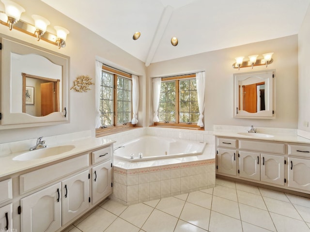 bathroom with a relaxing tiled tub, tile patterned flooring, vaulted ceiling, and vanity