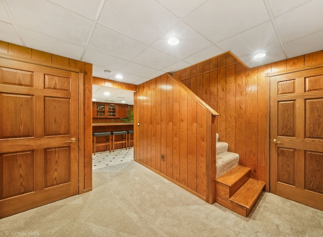 interior space with wooden walls and carpet