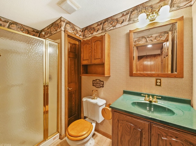 bathroom featuring a textured ceiling, walk in shower, tile patterned flooring, and vanity