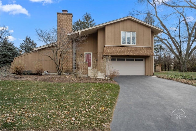 view of front of property with a front yard and a garage