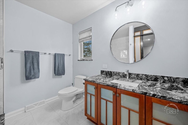 bathroom with toilet, tile patterned flooring, and vanity