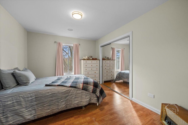 bedroom with a closet and hardwood / wood-style flooring