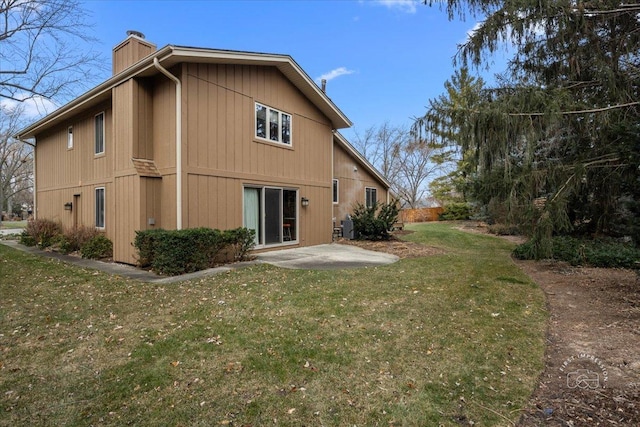 rear view of house featuring a yard, central air condition unit, and a patio area