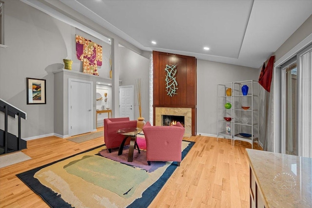 living room featuring hardwood / wood-style flooring and a premium fireplace